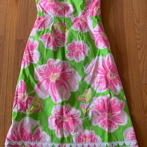 Lilly Pulitzer green strapless A line dress with bright pink flowers.
